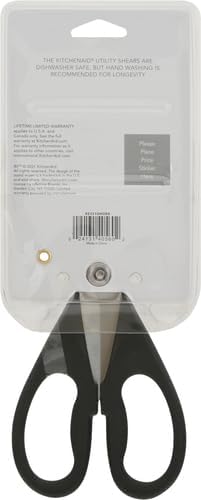 Black-handled scissors in clear packaging with text on a gray background