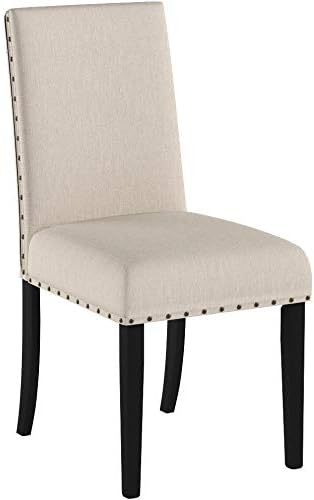 Beige upholstered chair with black legs on a white background