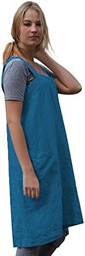 Woman wearing a blue apron over a gray shirt on a white background