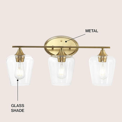 JONATHAN Y 23" Brass Gold 3-Light Farmhouse Rustic LED Vanity Light Sconce, Clear Glass Shade, Vintage Indoor Fixture for Bathroom Mirror, LED Bulb Included (JYL7547B)