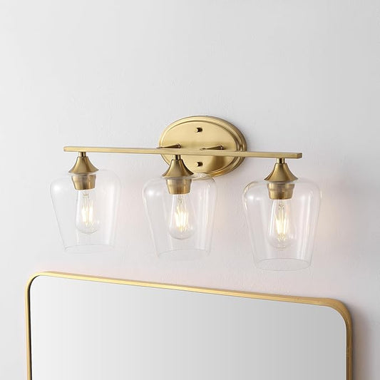 JONATHAN Y 23" Brass Gold 3-Light Farmhouse Rustic LED Vanity Light Sconce, Clear Glass Shade, Vintage Indoor Fixture for Bathroom Mirror, LED Bulb Included (JYL7547B)