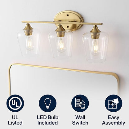 JONATHAN Y 23" Brass Gold 3-Light Farmhouse Rustic LED Vanity Light Sconce, Clear Glass Shade, Vintage Indoor Fixture for Bathroom Mirror, LED Bulb Included (JYL7547B)
