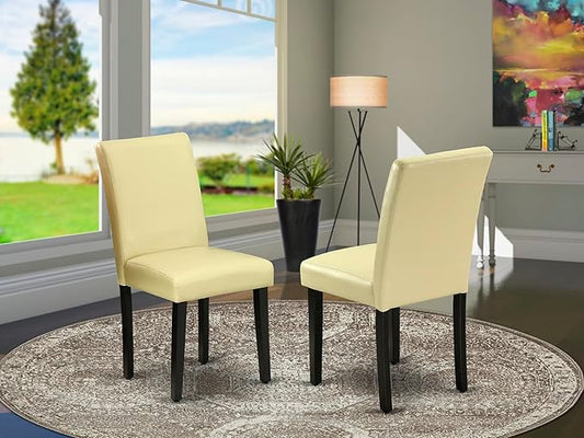 East West Furniture ABP1T73 Abbott Parson Dining Room Chairs - Eggnog Faux Leather Upholstered Chairs, Set of 2, Black